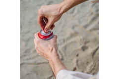 Image Person holding beverage can.